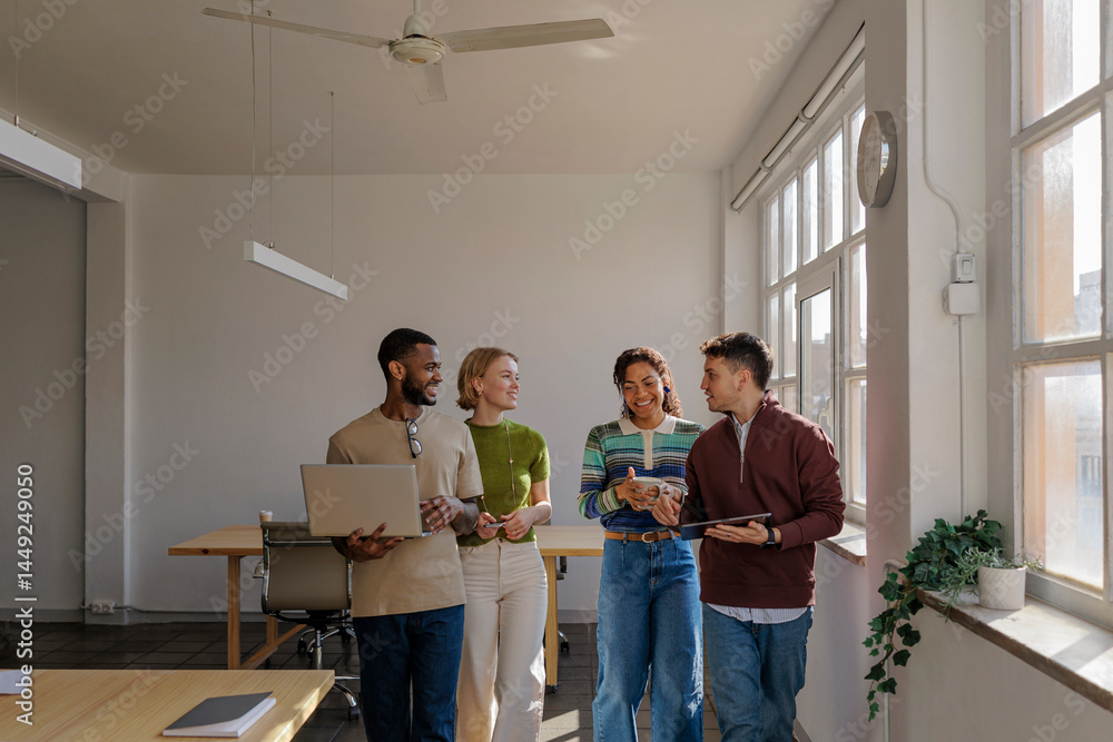 Diverse startup team walking and talking in modern office Diverse startup team walking and talking in modern office