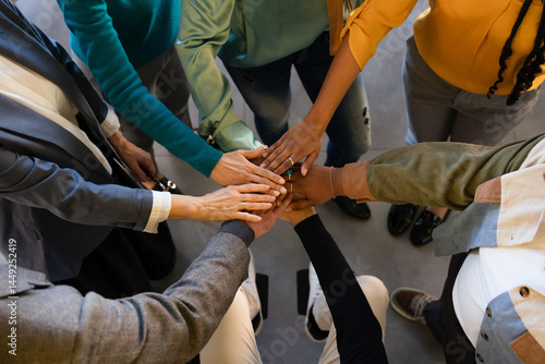 Diverse team uniting hands in a collaborative gesture