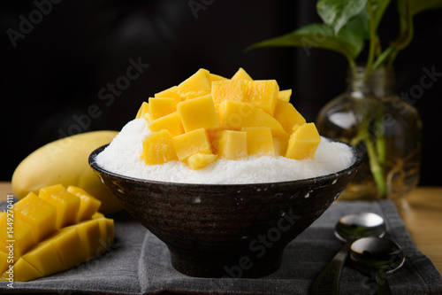 Photography Mango shaved ice in a black bowl, a summer dessert