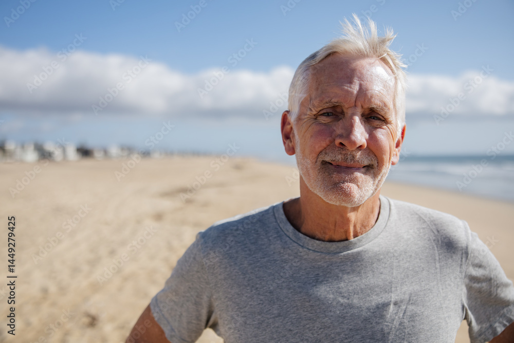 Smiling Older Man on a Beach Under Clear Blue Sky Smiling Older Man on a Beach Under Clear Blue Sky
