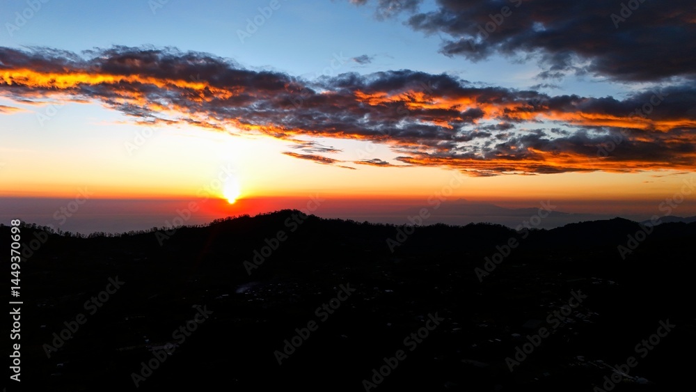 Fototapeta premium sunrise in the mountains with golden gradation of light on dark textured clouds