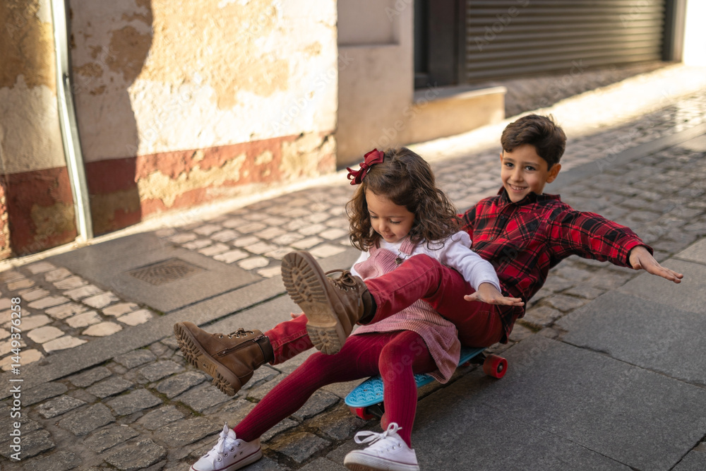 siblings having fun riding a skateboard siblings having fun riding a skateboard