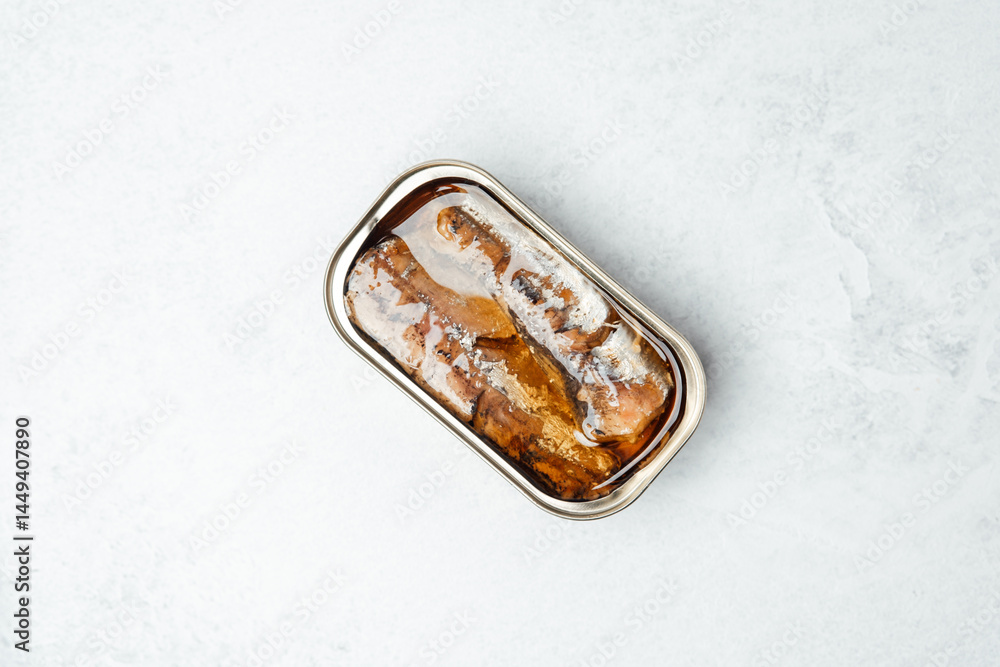 Delicious grilled fish served in a sleek metal container on a light surface Delicious grilled fish served in a sleek metal container on a light surface