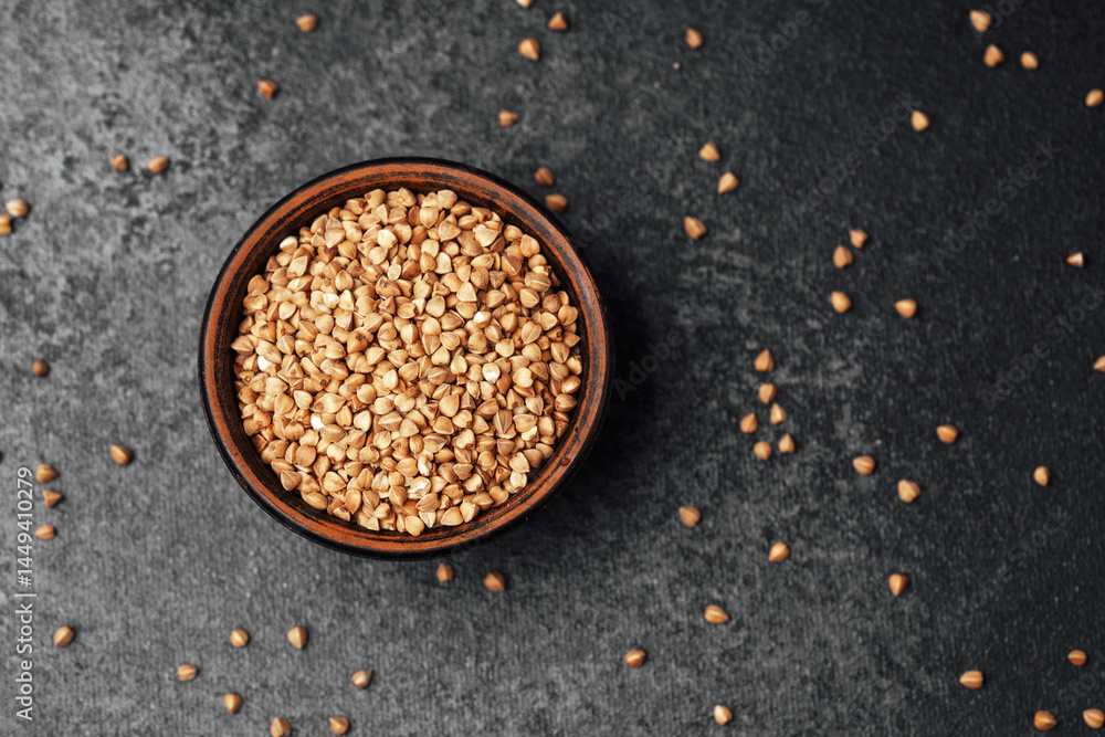 High-quality sesame seeds in a rustic bowl on a dark surface High-quality sesame seeds in a rustic bowl on a dark surface