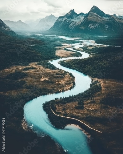 Serpentine River Flowing Through Majestic Mountain Valley Landscape from Above View