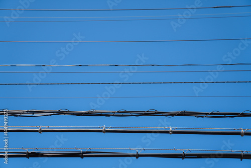 Overhead Utility Wires Against a Clear Blue Sky