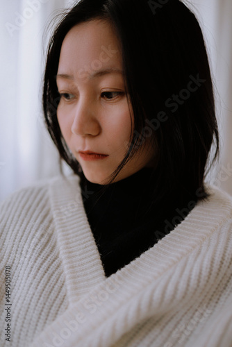 A quiet moment of a woman with a hint of sadness.