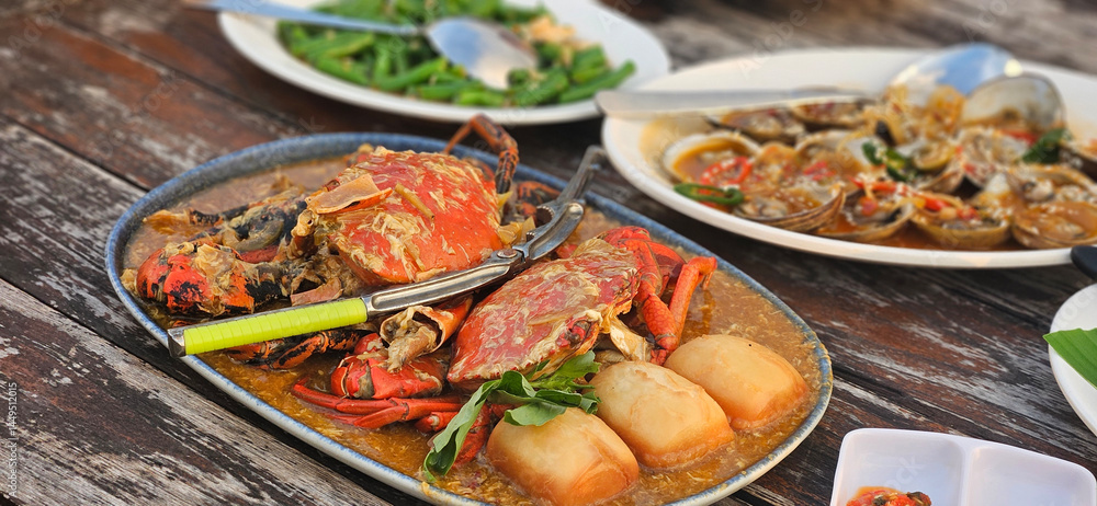 Chilli crab Singapore style serving with fried bun on the timber table Chilli crab Singapore style serving with fried bun on the timber table