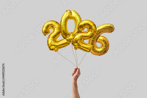 Woman holding 2026 balloons