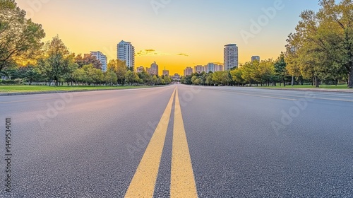 Obraz na płótnie Cityscape View from Asphalt Road with Yellow Lines at Sunset in Urban Park Setting w salonie