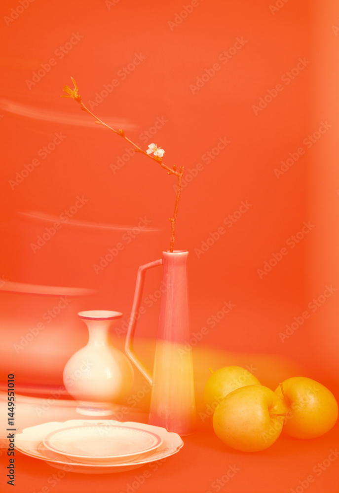 © Irina Ozhigova/Stocksy - Still life composition featuring a glass jug, fruit, and a branch with