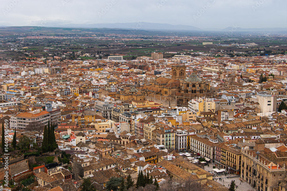 Obraz premium A panoramic view of the City of Granada in Spain on a cloudy morning as seen from the Alhambra Palace.