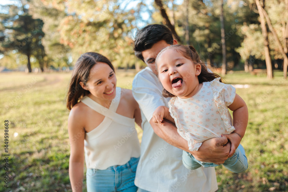 Playful young parents lifting their daughter Playful young parents lifting their daughter