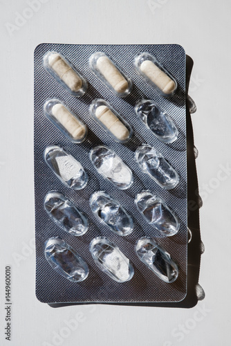 Blister Pack with Partially Used Capsules on White Background