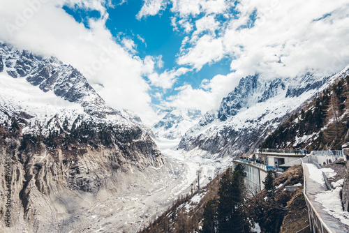 Discover the scenic viewpoint and panoramic views of the Montenvers Mer de Glace and Mont Blanc mountains, and the red train in Chamonix, Haute-Savoie, France.