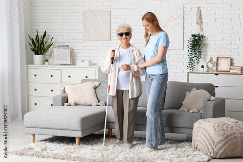 Fotografi Young woman with blind grandmother at home