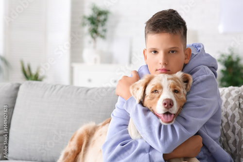 Teenage boy sitting on sofa...