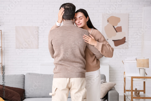 Young woman hugging her hus...