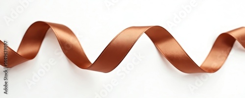Copper ribbon isolated on white background. Wavy elegant design for decoration gift wrapping. Shiny smooth textile ribbon with warm metallic color. Festive design element for holidays, celebration.