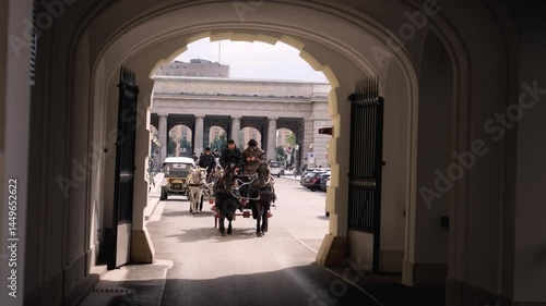  24.04.2024 Horse carriage in Vienna, Austria. Historic carriage ride through archway in city center showcasing elegance and tradition. Travel concept.