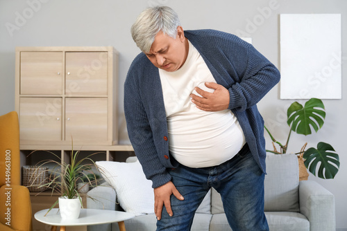 Senior man having heart att...