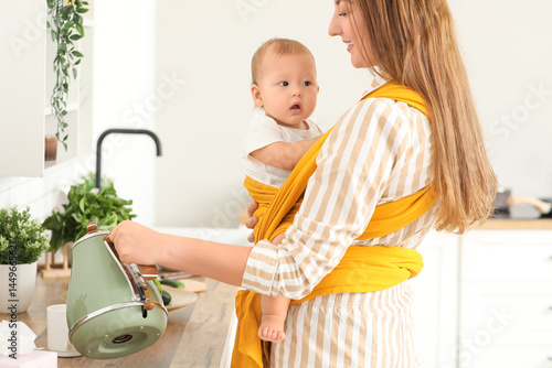Young mother pouring water ...
