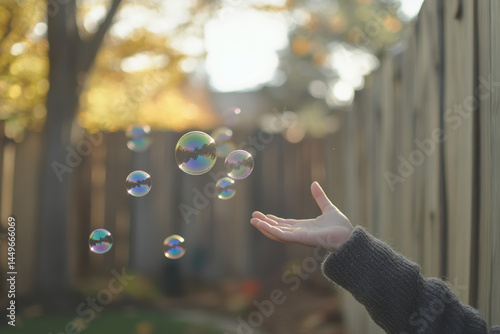 Faceless Child Reaching for Bubbles