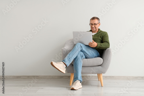 Old man with laptop sitting...