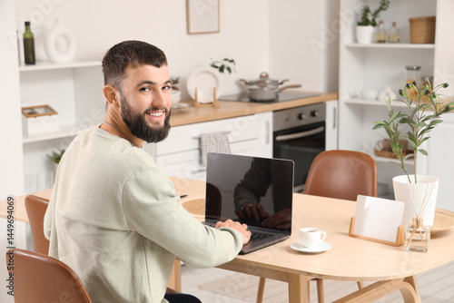 Young bearded man working w...