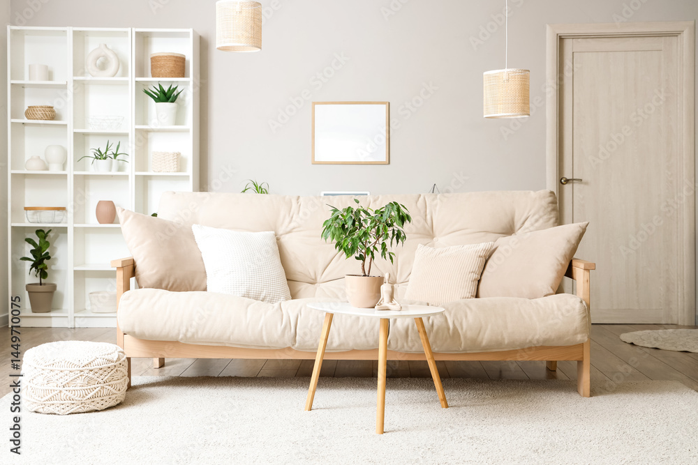 Obraz premium Interior of light living room with beige sofa, table and shelf unit