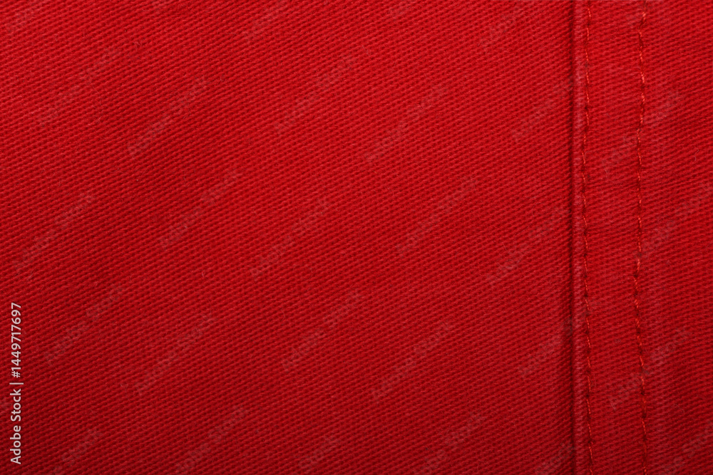 Fototapeta premium Red denim jeans texture close up. Red denim jeans background.