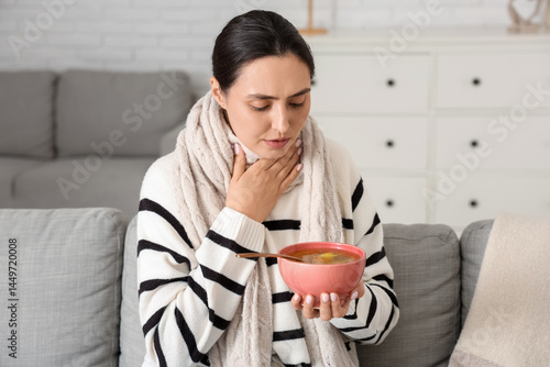 Sick young woman with soup ...
