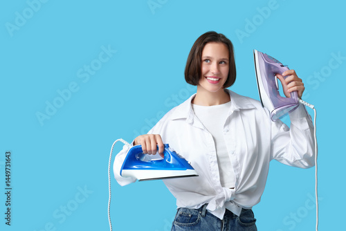 Smiling young woman holding...