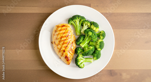 Grilled chicken breast with steamed broccoli on a plate  