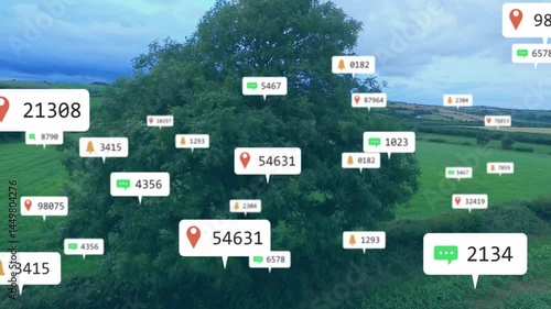 Large green tree visualizing in rural fields, displaying floating red pin chat notification icons