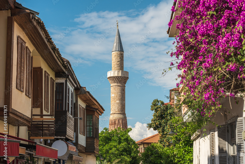 Naklejka premium Sehzade Korkut Mosque or Kesik Minaret, seen among the historical houses in the streets of Antalya Old Town