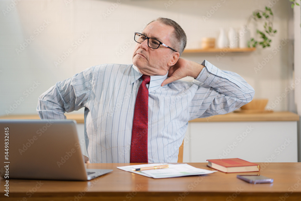 Mature male stretches to ease office syndrome from prolonged sitting. Mature male stretches to ease office syndrome from prolonged sitting.