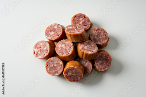 Close-up of Sliced Smoked Sausage on White Background Ready for Cooking or Serving