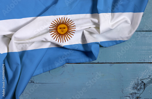 waving colorful national flag of Argentina on wooden table