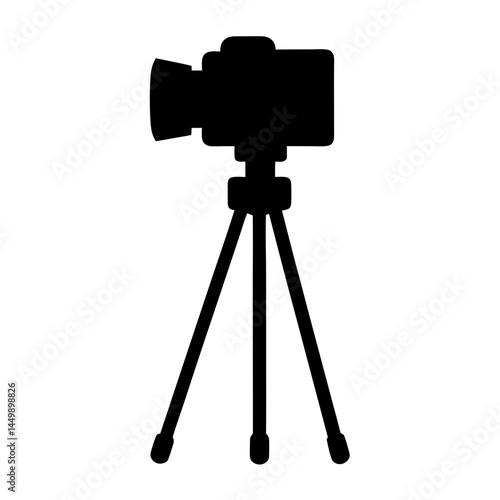 Silhouette of a professional video camera mounted on a sturdy tripod