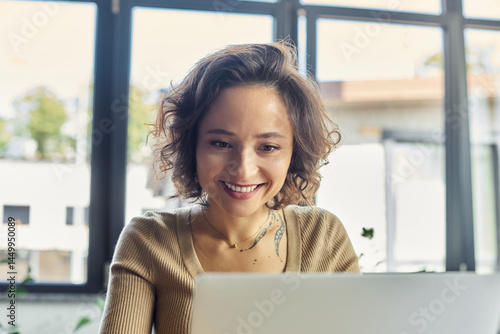 Focused professional enjoys working on a laptop in a bright office space during daylight hours Free Download Focused professional enjoys working on a laptop in a bright office space during daylight hours - GFXLoad