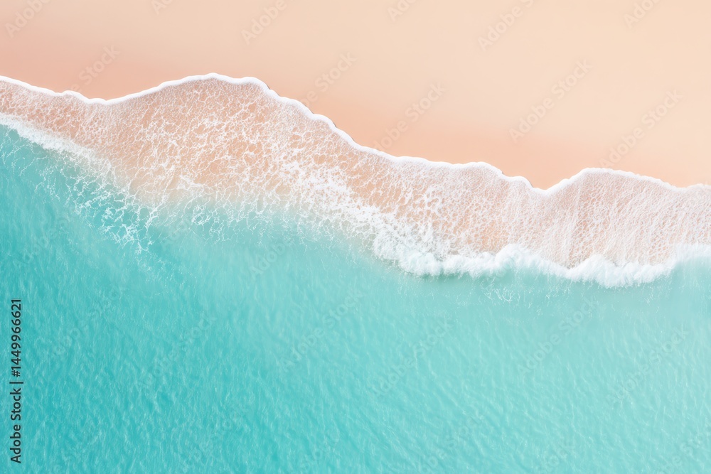 Fototapeta premium Aerial view of turquoise waves gently washing onto a sandy beach with foamy surf.