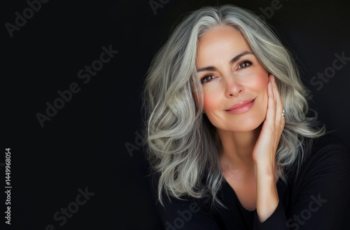 Adult elderly and beautiful woman 50 years old. Smiling charming mature woman , touches her cheek. Beauty and care cosmetology for mature facial skin. Makeup and cosmetology. adult skin, older lady