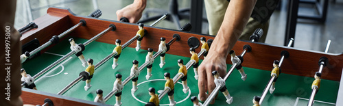 Obraz na plátně Engaging in a spirited foosball match to foster team spirit and collaboration in