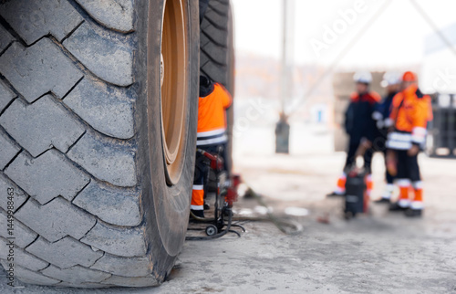 Obraz na płótnie Replacing tires on wheels of mining dump car in garage. Maintenance fix service of industry truck w salonie