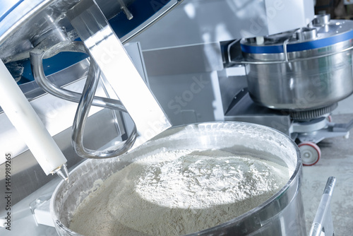 Fotografie Dough mixing process in confectionery industry, automated machines preparing puf