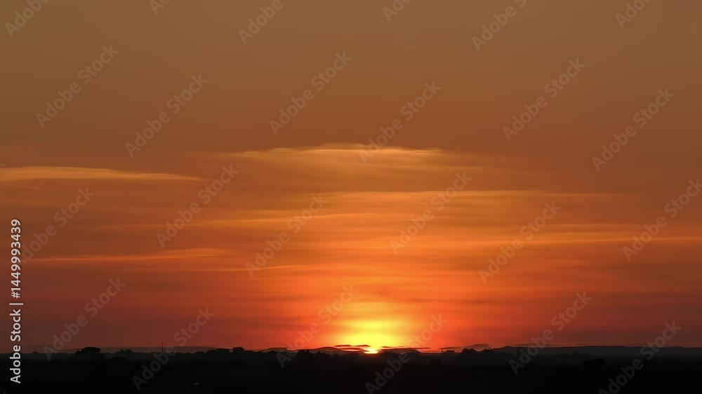 Stunning Sunset Over a Horizon with Soft Clouds and Vibrant Orange and Yellow Hues, Casting a Serene Glow on the Landscape, Perfect for Nature Lovers Stunning Sunset Over a Horizon with Soft Clouds and Vibrant Orange and Yellow Hues, Casting a Serene Glow on the Landscape, Perfect for Nature Lovers