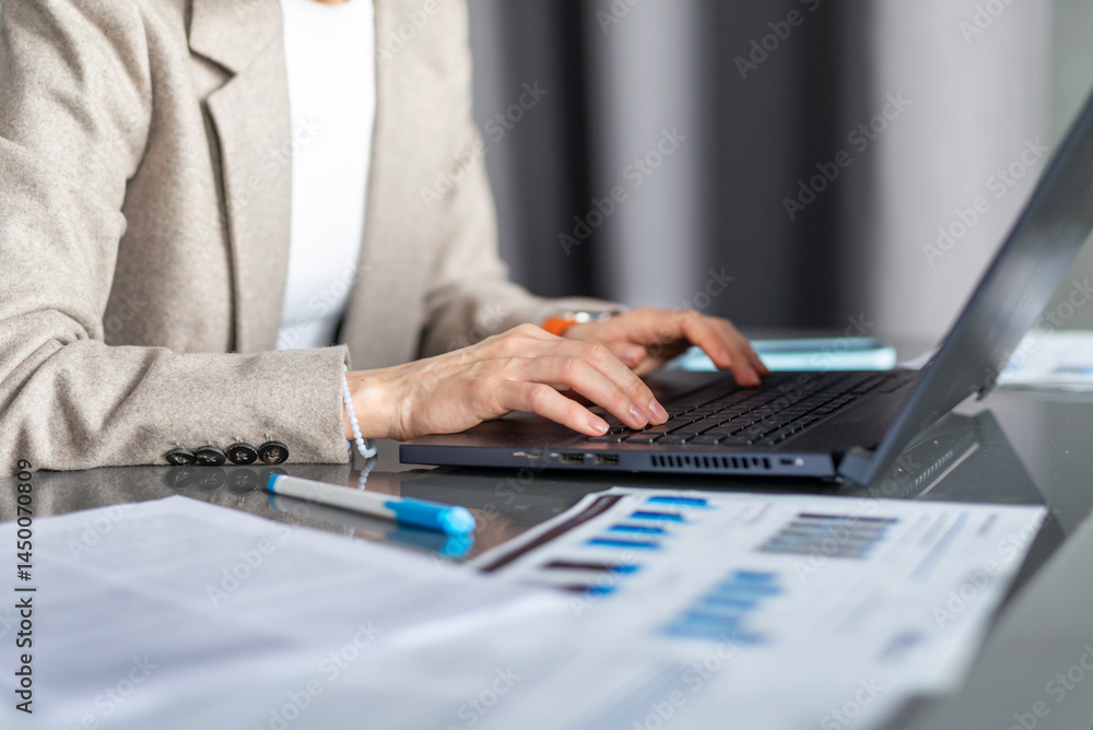 Woman working with laptop and documents analyzing data or writing reports Workplace office or home Woman working with laptop and documents analyzing data or writing reports Workplace office or home
