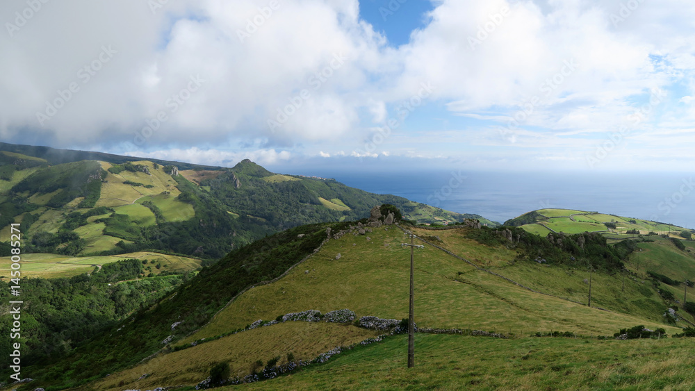 Fototapeta premium Miradouro Pico da Casinha - This viewpoint offers fantastic views over the green hills of Ribeira dos Barqueiros 