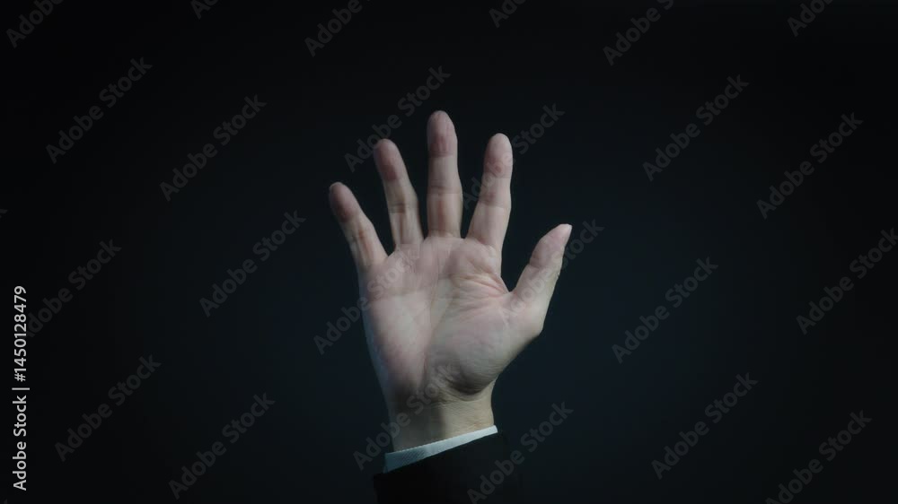Businessman counting from one to five on dark background Businessman counting from one to five on dark background